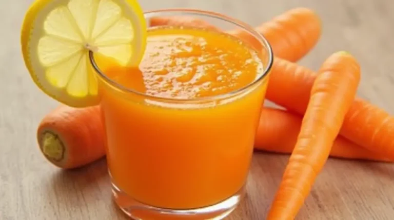 Carrot Juice Recipe - Freshly prepared carrot juice served in a glass with lemon and carrot sticks